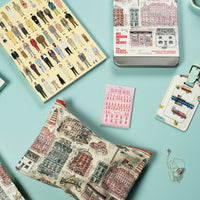 Collection of travel-themed products with cityscape designs on a light blue background