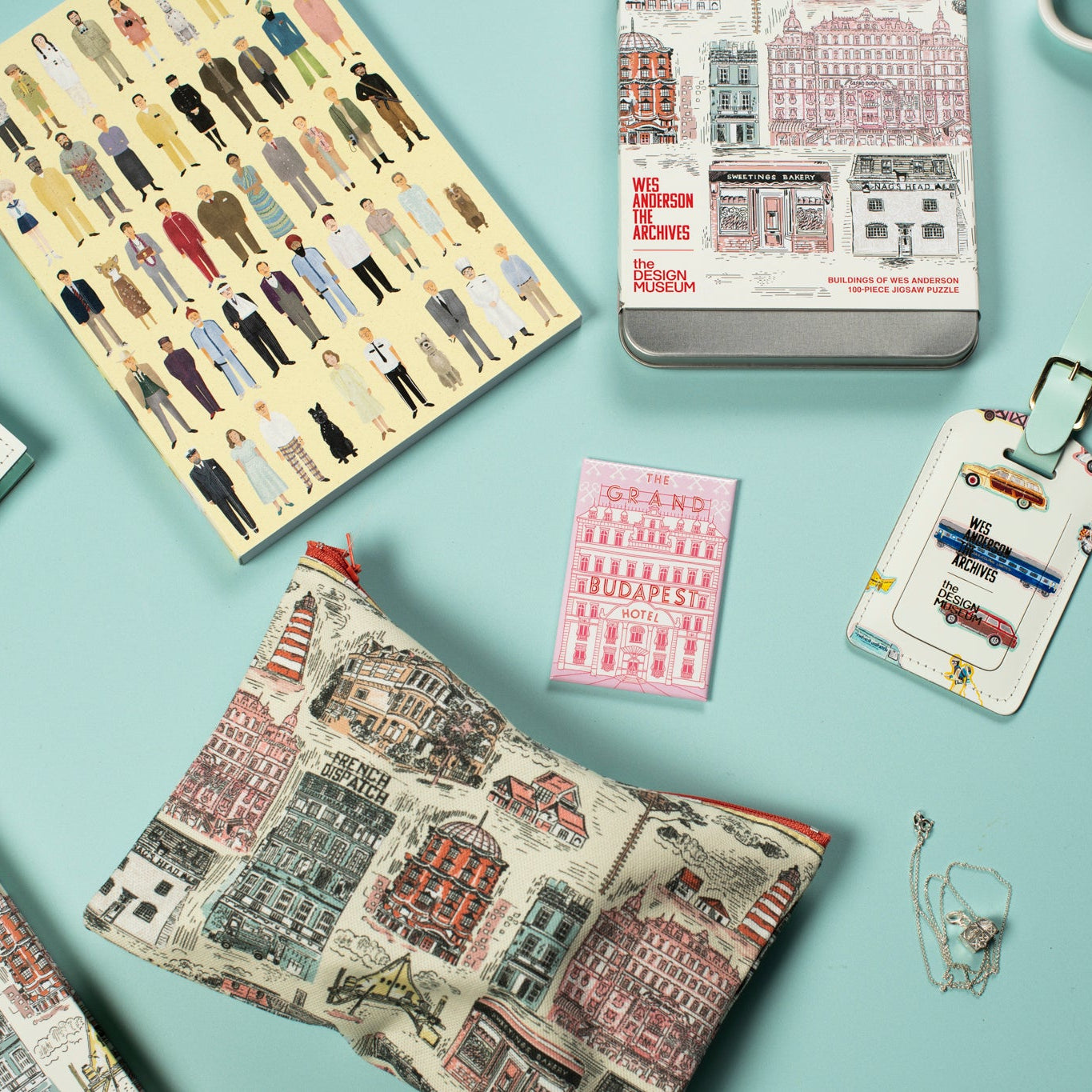 Collection of travel-themed products with cityscape designs on a light blue background