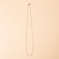 Long necklace on a beige background