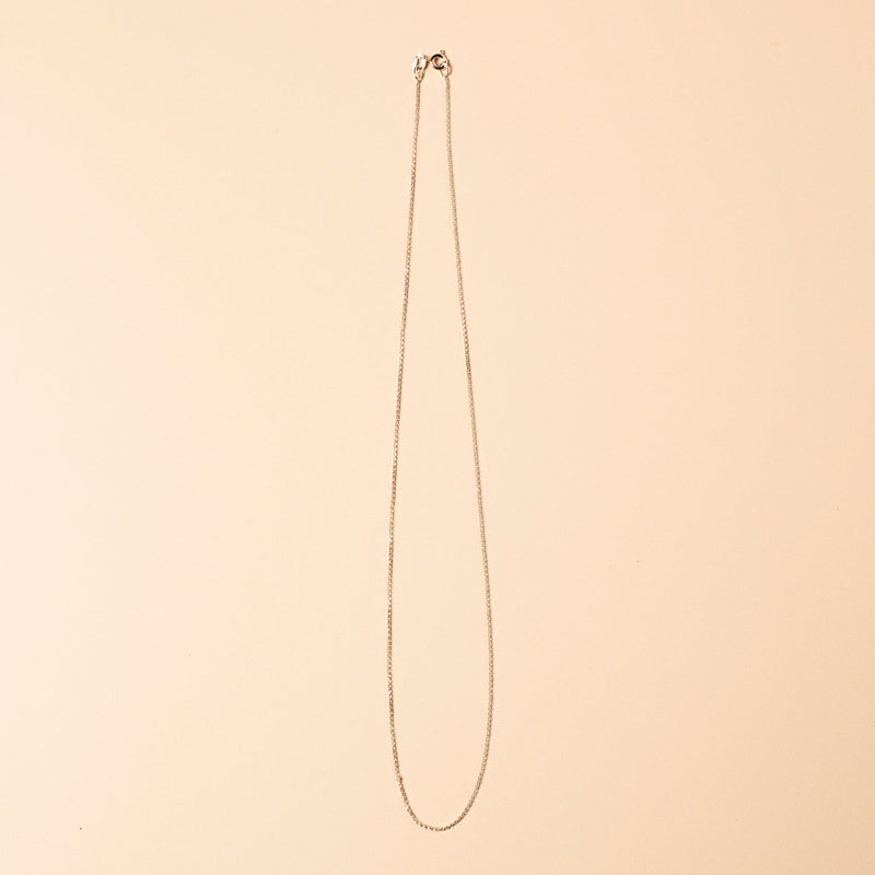 Long necklace on a beige background