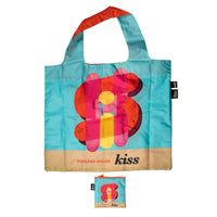 Colorful tote bag with floral design and 'kiss' branding on a beige background