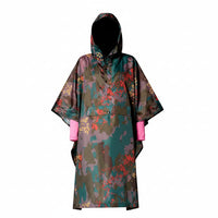 Person wearing a colorful raincoat with a pattern on a plain background