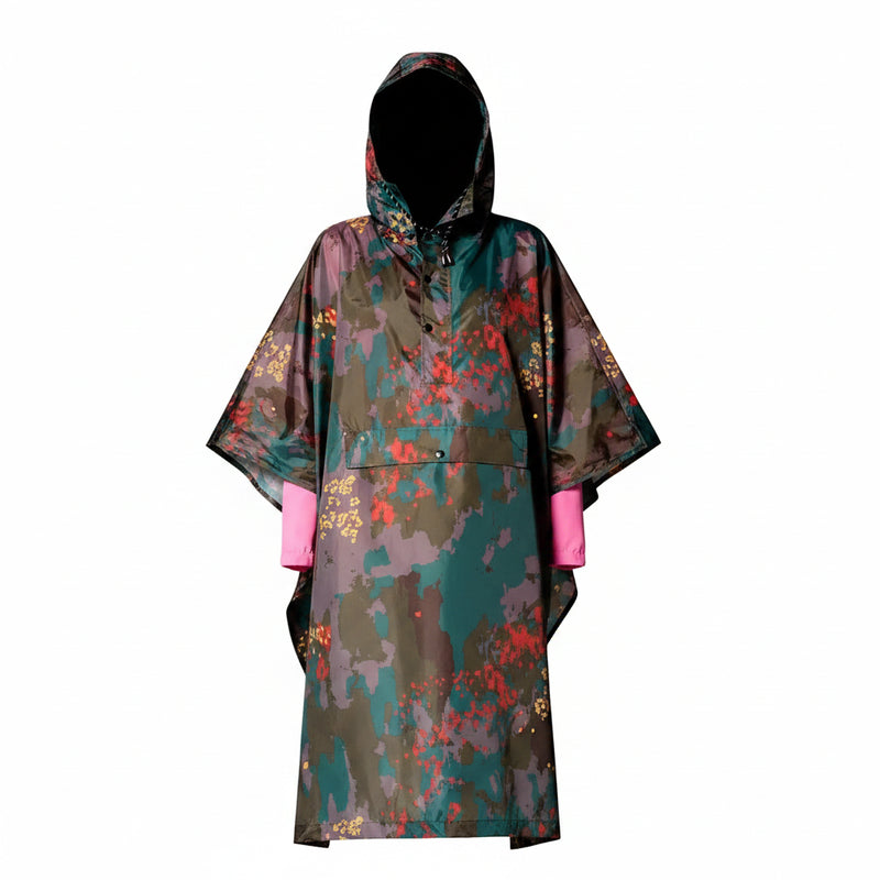 Person wearing a colorful raincoat with a pattern on a plain background