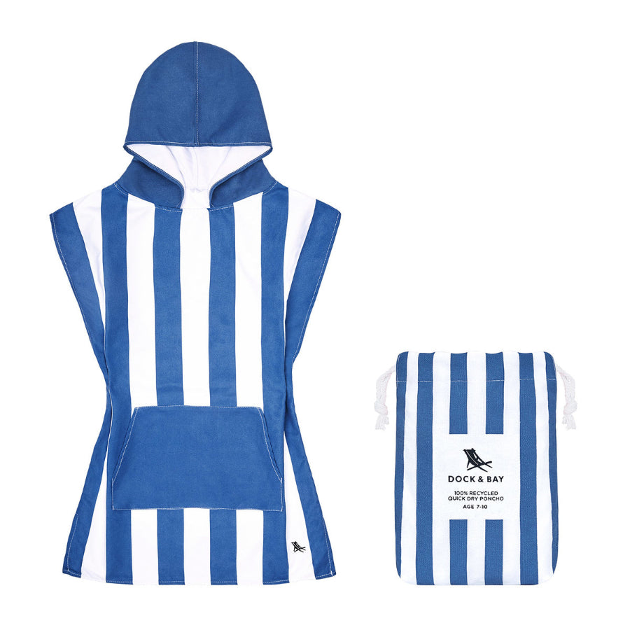 A blue and white striped towelling poncho next to its bag with the same pattern.