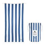 Dock & Bay Towel white and blue stripes laid flat with its bag on white background.