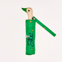 Closed umbrella in a green sleeve with a duck shaped wooden handle
