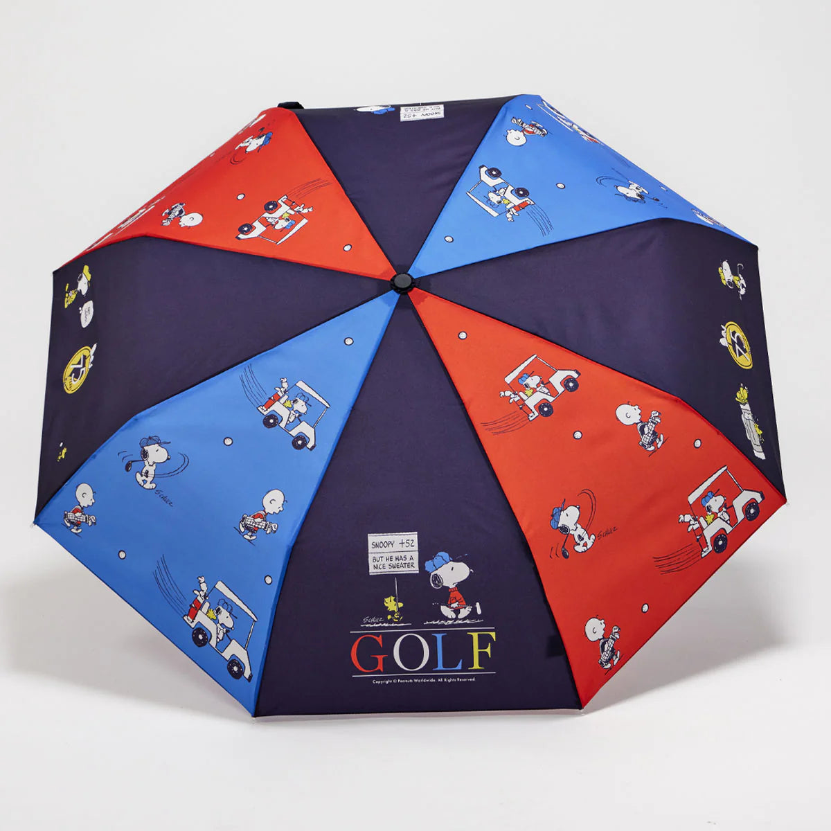 Open umbrella with retro Snoopy design and red and blue panels