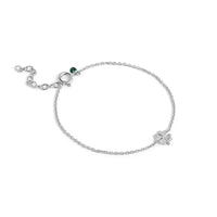 Silver bracelet with a clover charm on a white background