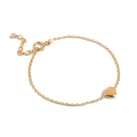 Gold bracelet with a heart-shaped charm on a white background