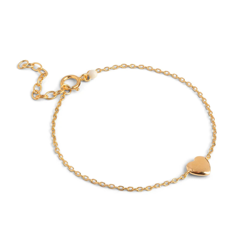 Gold bracelet with a heart-shaped charm on a white background