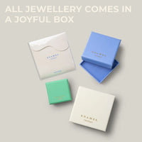 Four enamel jewelry gift boxes in white, light blue, and mint green arranged on a light gray background.