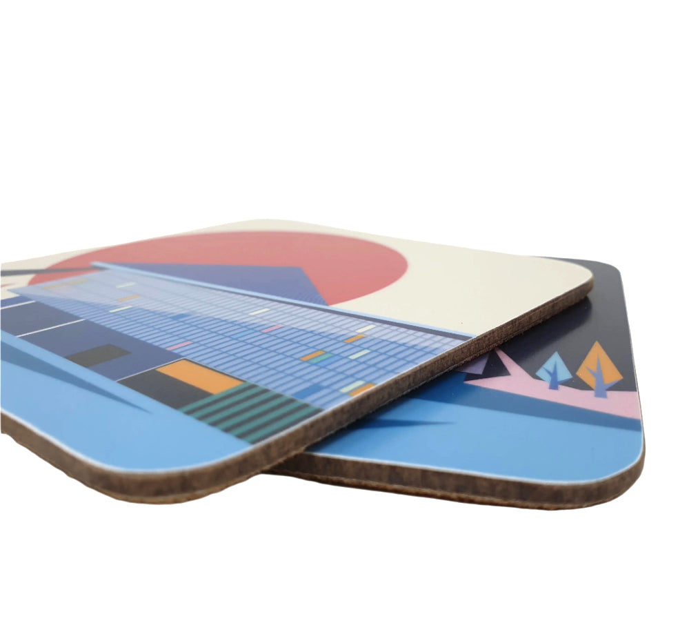 Closeup of a pair of square coasters with cork backing with a colourful graphic design of the Design Museum