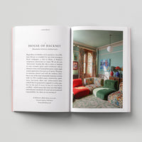 Open page of Eco London book featuring a photograph of a room with colourful sofas.