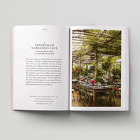 Open page of Eco London book featuring a photograph of Petersham Nurseries Cafe with lots of tables and greenery.