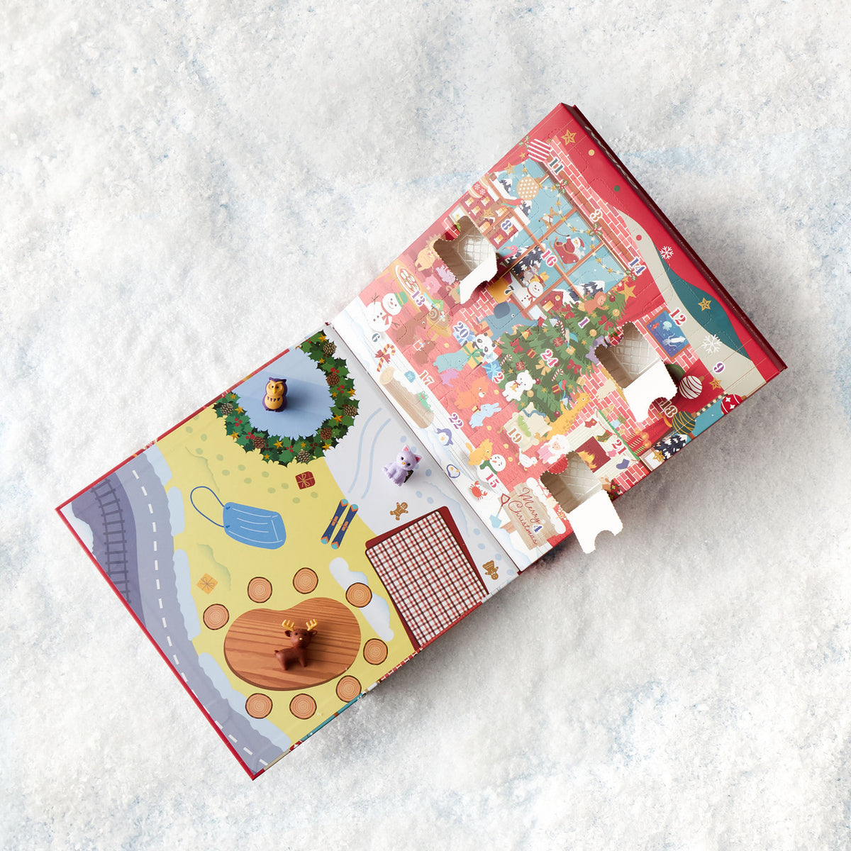 Colorful Christmas eraser advent calendar pieces on a light gray surface