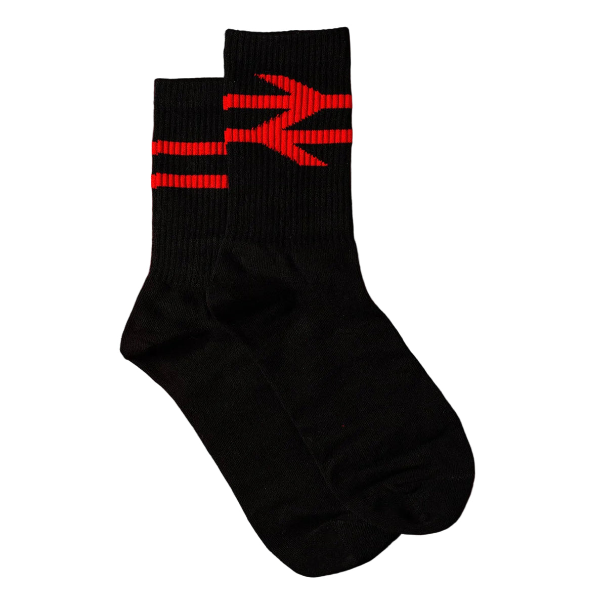 A pair of black crew socks with a red graphic pattern on the upper cuff, laid flat on a solid red background.