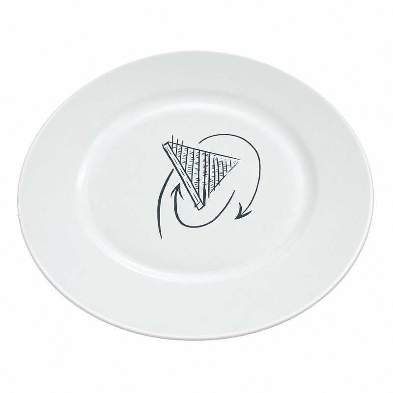 A white ceramic plate with a black hand-drawn graphic in the center, placed on a light wood desk with cardboard boxes in the background.