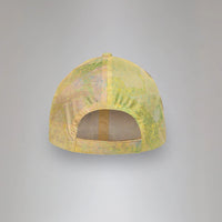 Yellow cap with mesh design on a gray background