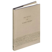 Grey covered book called the lyrics of Gary Kemp on a white background