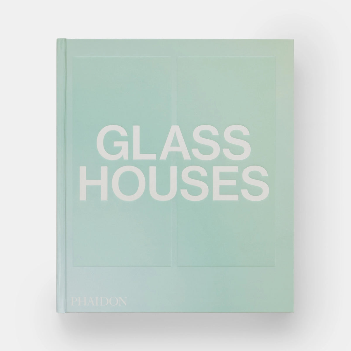 The cover of the book 'Glass Houses' by Phaidon Press, featuring a minimalist design with the title text in white on a light blue background.