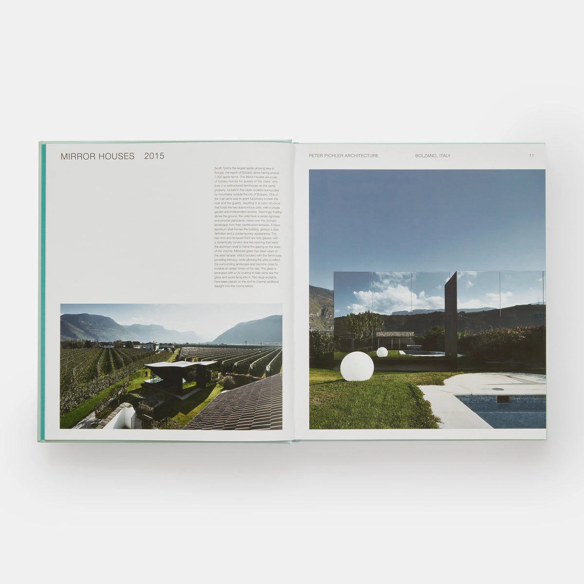Open page of Glass Houses book featuring a photograph of a house made from mirrors next to grass and a pool. 