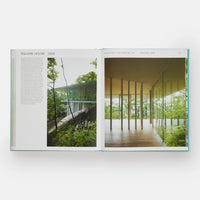 Open page of Glass Houses book featuring a photograph of a modern glass house amongst a forest.