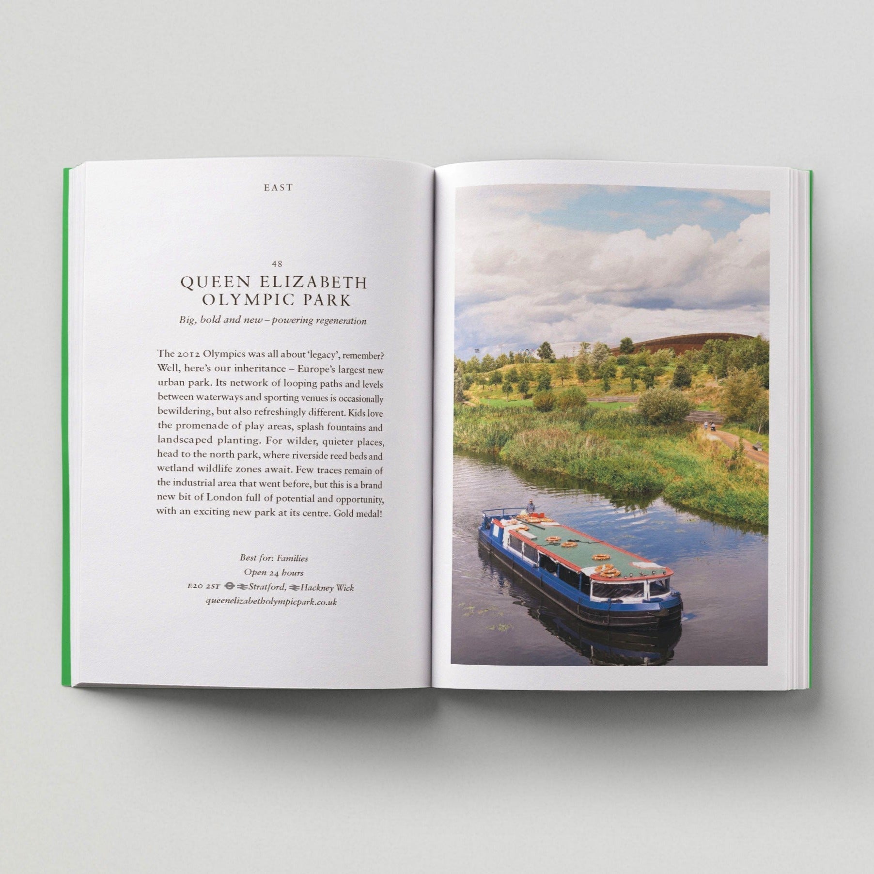Open page of London Green Spaces book featuring a photograph of a boat on a canal next to Queen Elizabeth Olympic Park.