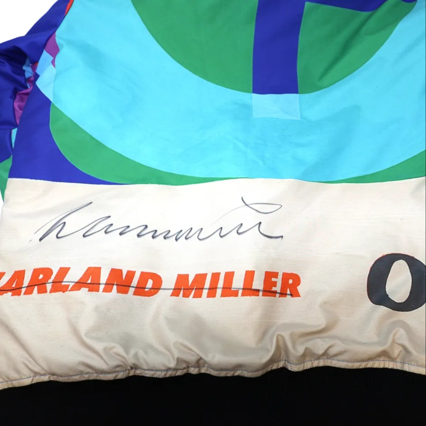 Colorful jacket with 'Harland Miller' signature on a white background