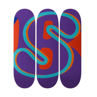 Three skateboard decks with colorful abstract designs on a white background