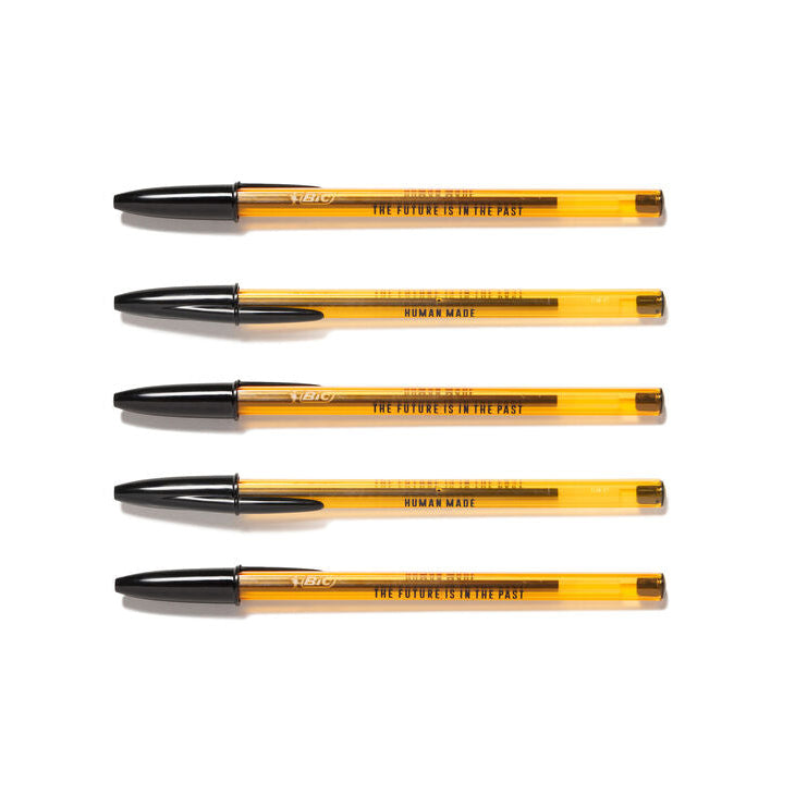 Four orange pens with black lids on a white background