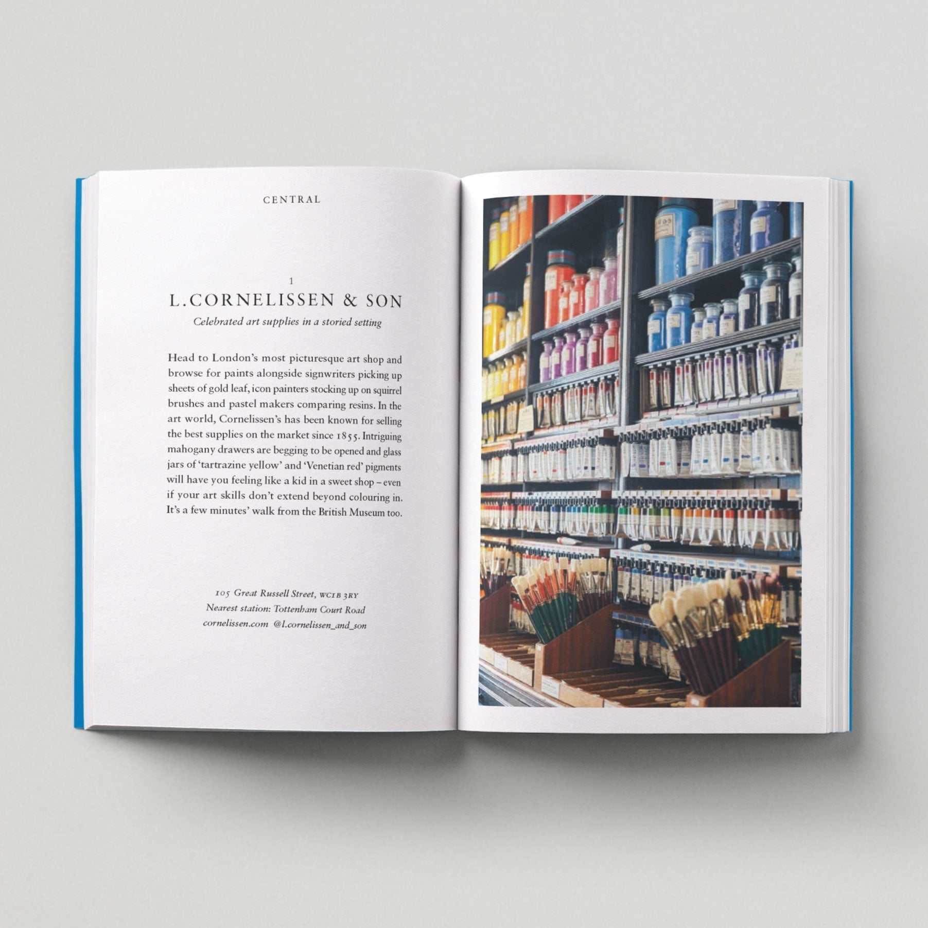 Open page of Independent London book featuring a photograph of an art shop with paints of various colours and paintbrushes.