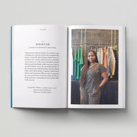 Open page of Independent London book featuring a photograph of a person standing in front of rails of clothing.