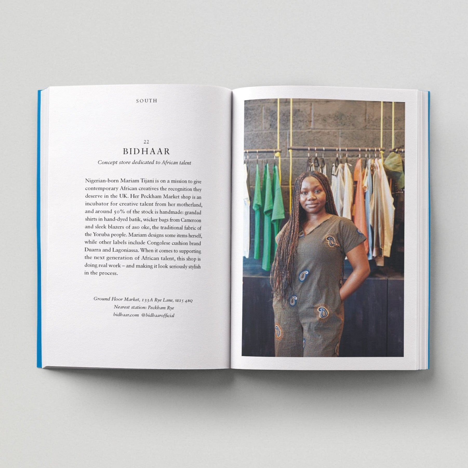 Open page of Independent London book featuring a photograph of a person standing in front of rails of clothing.