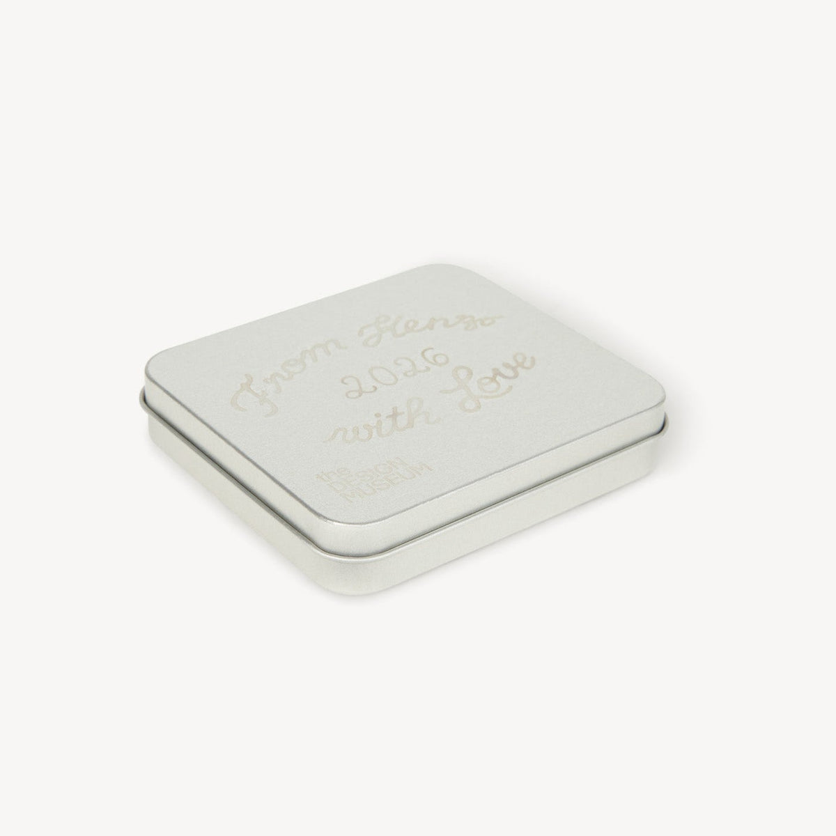 Small rectangular tin with a lid on a white background