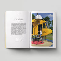 Open page of Kids London book featuring a photograph of a child sitting on a yellow helicopter-shaped playground apparatus.