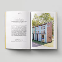 Open page of Kids London book featuring a photograph of a child in a model house. 