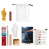 Kintsugi repair kit with gold powder, resin, tools, and instructions on a white background.