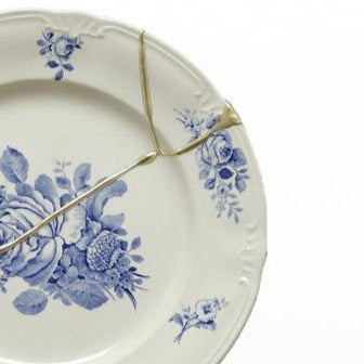 floral china plate with gold kintsugi repair.