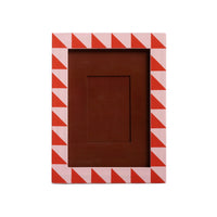 Rectangular photo frame with red and white chevron pattern on a light gray background