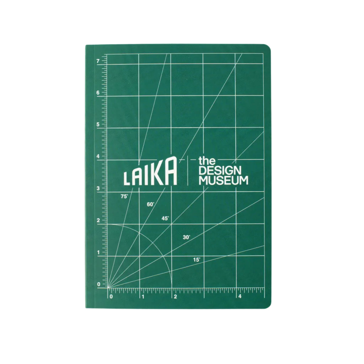 A green note book with white grid lines and the text 'LAIKA the DESIGN MUSEUM' in the center, photographed flat against a light beige background.