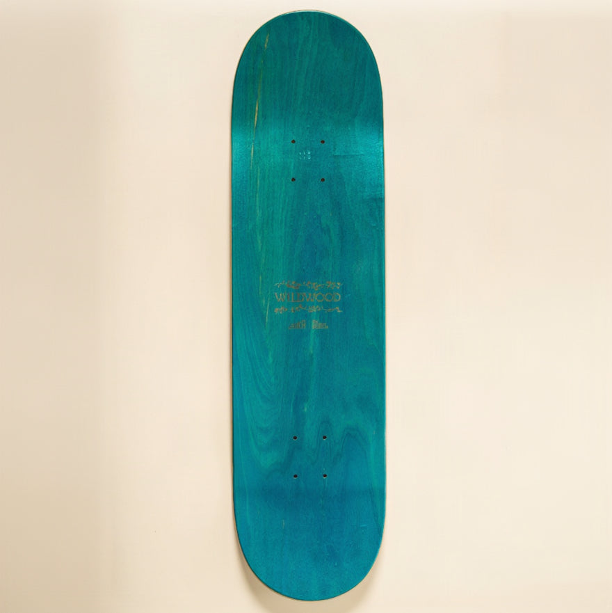 A skateboard deck with a vibrant teal and turquoise wood grain finish, displayed horizontally against a solid cream-colored background.