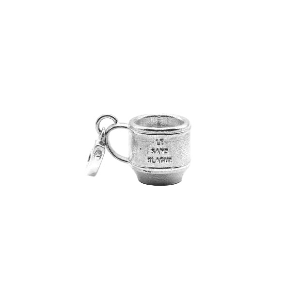 Silver teacup shaped charm engraved with 'Le Sans Blague' on a white background 