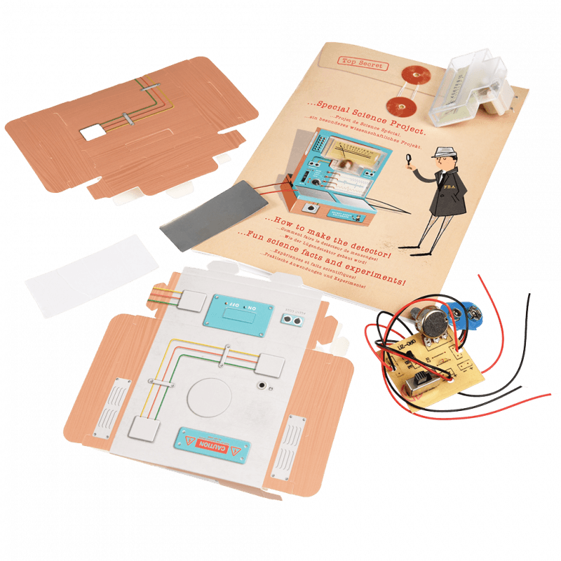 Science project kit with components and instructions on a green textured background