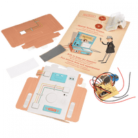 Science project kit with components and instructions on a green textured background