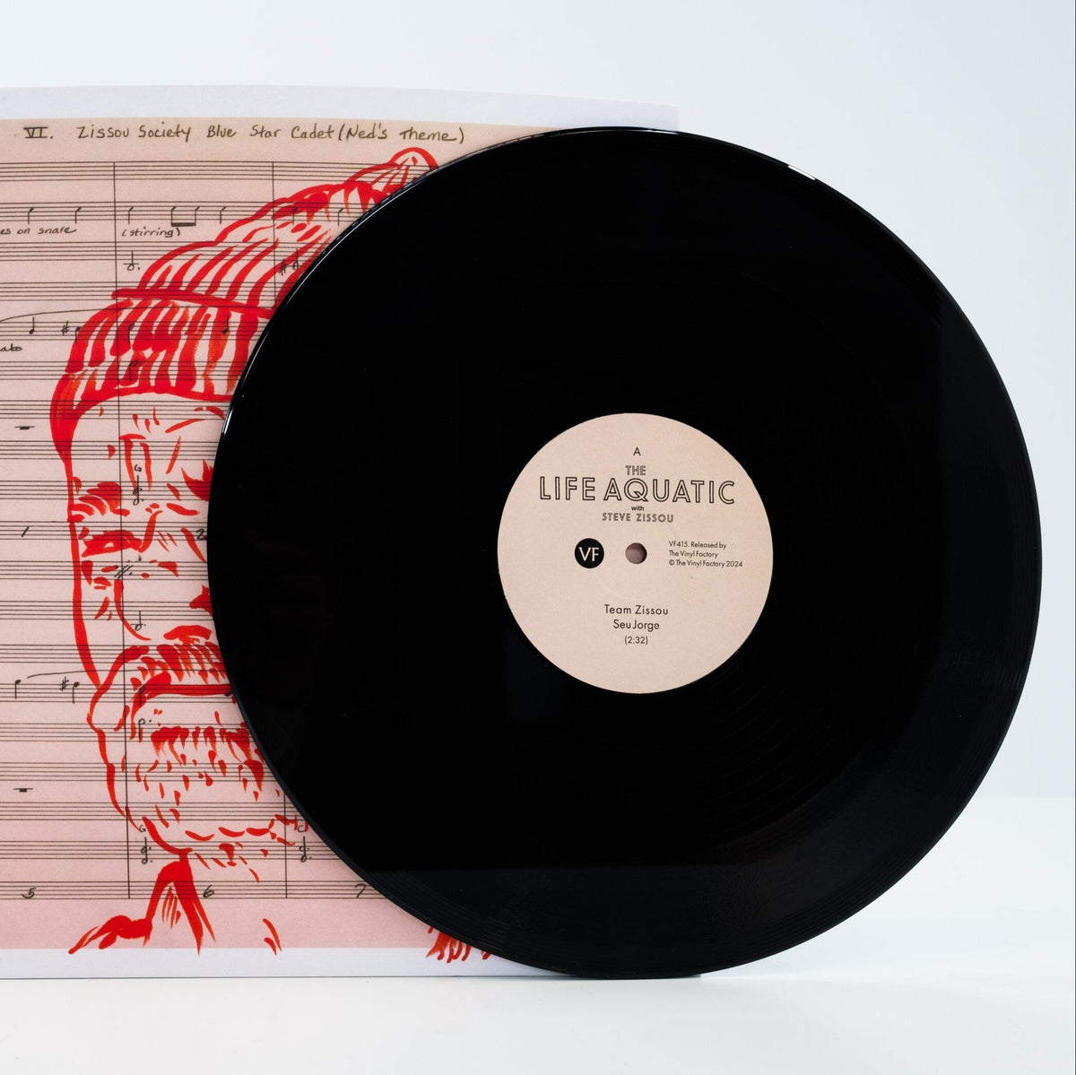 Vinyl record with 'Life Aquatic' label on a sheet of music