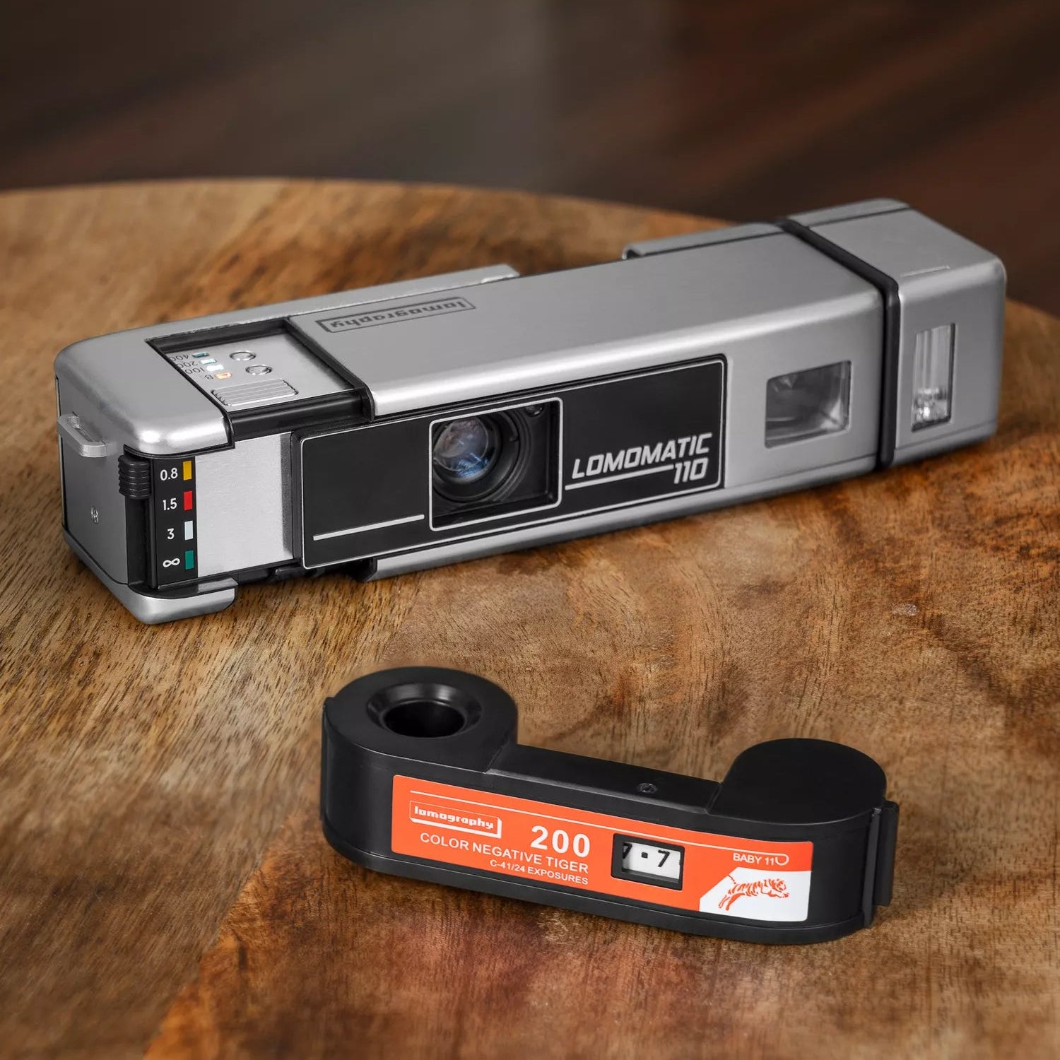 Silver vintage Lomomatic 110 camera on a wooden surface