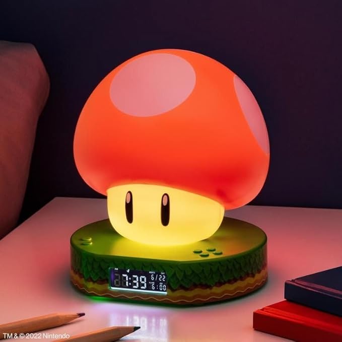 red and white mushroom-shaped night light with digital clock on a table