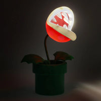 Flaming torch plant lamp from a video game on a dark background