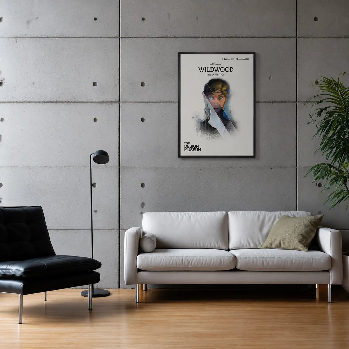 Framed poster of the film Wildwood on a grey concrete wall above a white leather sofa