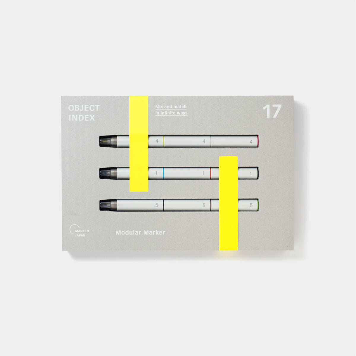 A set of three white modular marker pens in rectangular grey packaging with neon yellow accents.